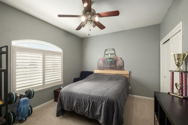 bedroom with baseboards, ceiling fan, and light colored carpet