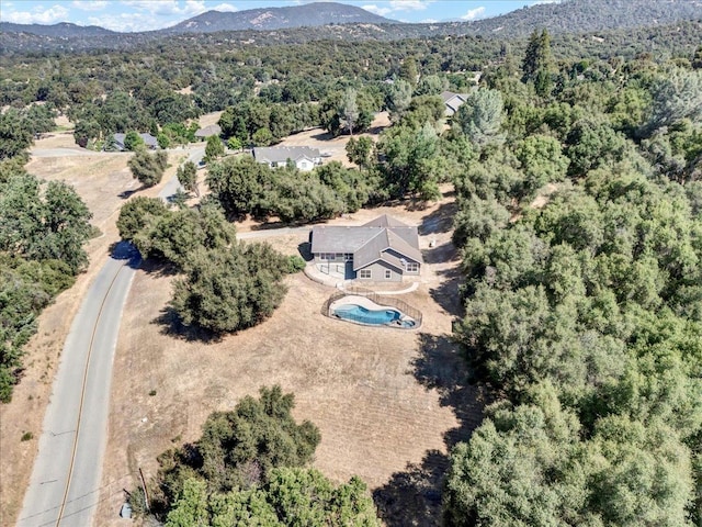 bird's eye view featuring a mountain view and a wooded view