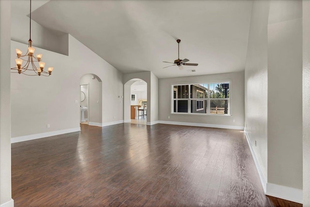 unfurnished living room with dark wood-style floors, baseboards, arched walkways, and ceiling fan with notable chandelier