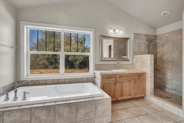 bathroom featuring lofted ceiling, tile patterned floors, a tile shower, vanity, and a bath