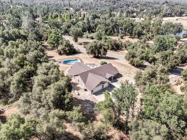 aerial view featuring a wooded view