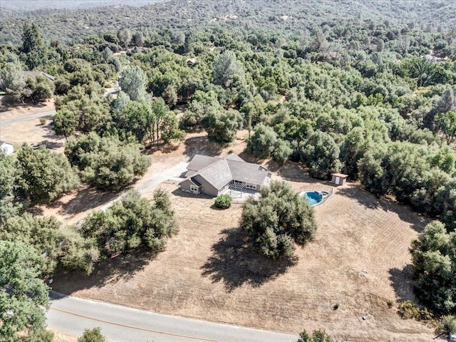 birds eye view of property with a view of trees