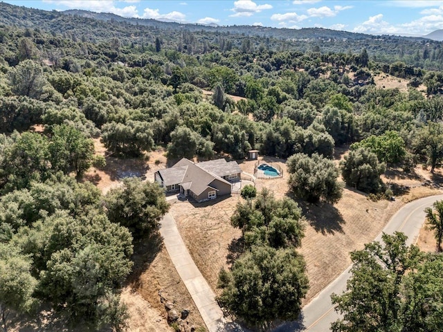 aerial view featuring a mountain view and a wooded view