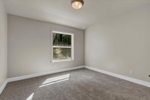 empty room featuring carpet flooring and baseboards