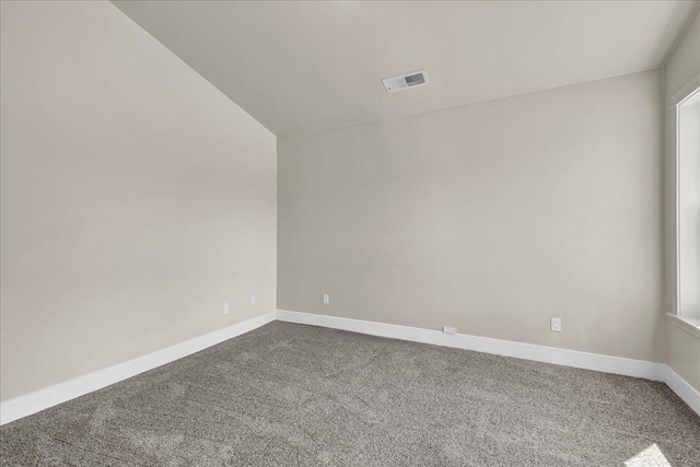 unfurnished room featuring carpet, visible vents, and baseboards