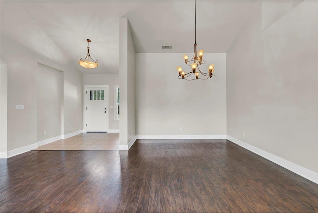 foyer entrance featuring visible vents, baseboards, a chandelier, and wood finished floors