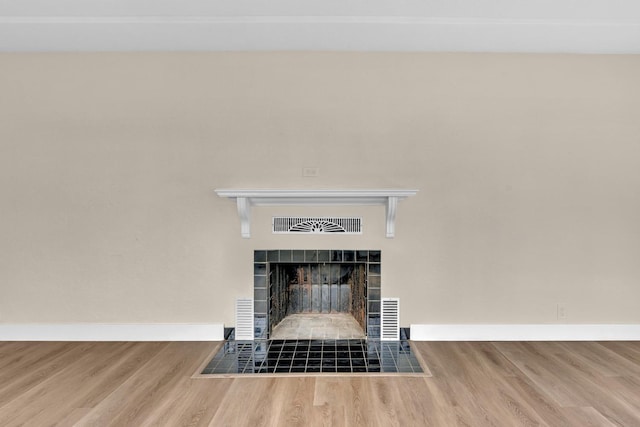 506 W Terrace Ave, Fresno, CA 93705 - detailed view of a tile fireplace, wood finished floors, and baseboards
