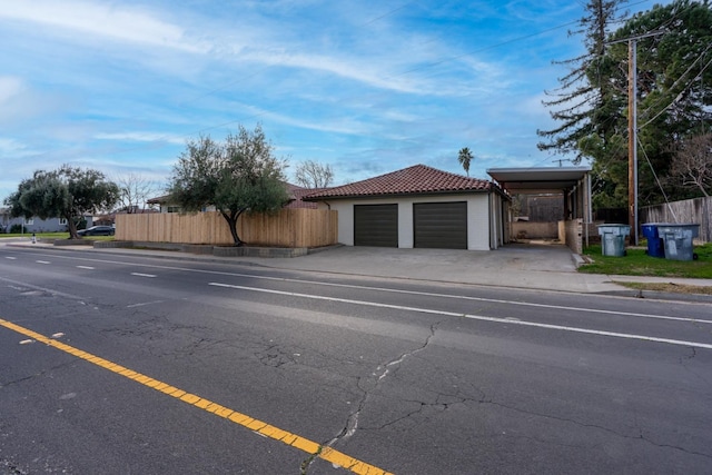 506 W Terrace Ave, Fresno, CA 93705 - garage featuring fence, driveway, and a carport