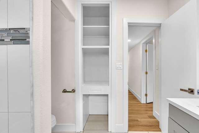 506 W Terrace Ave, Fresno, CA 93705 - bathroom with toilet, vanity, and wood finished floors