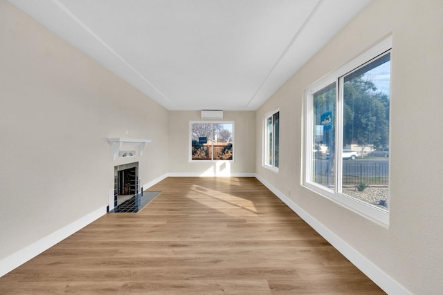 506 W Terrace Ave, Fresno, CA 93705 - unfurnished living room with a fireplace with flush hearth, light wood-style flooring, and baseboards