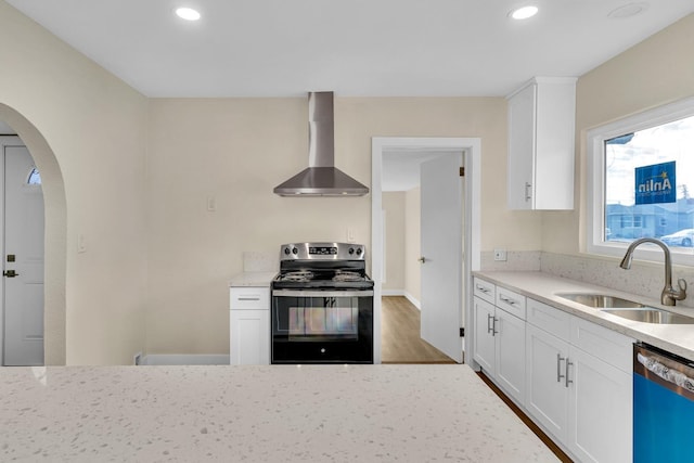 506 W Terrace Ave, Fresno, CA 93705 - kitchen featuring stainless steel electric range oven, wall chimney range hood, dishwashing machine, a sink, and arched walkways