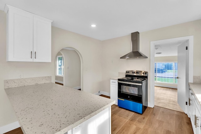 506 W Terrace Ave, Fresno, CA 93705 - kitchen featuring wall chimney range hood, electric stove, a peninsula, light wood finished floors, and recessed lighting