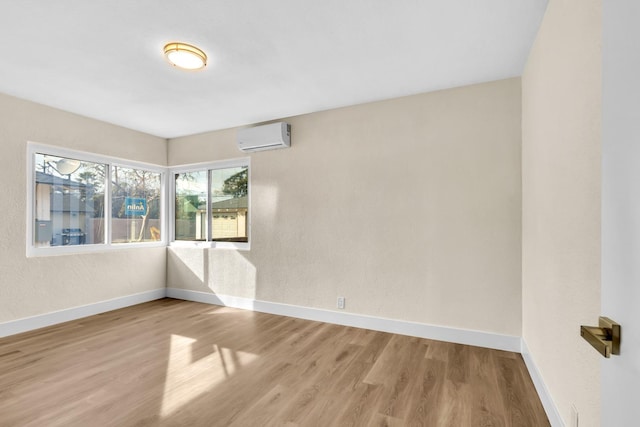 506 W Terrace Ave, Fresno, CA 93705 - empty room featuring a wall mounted AC, wood finished floors, and baseboards