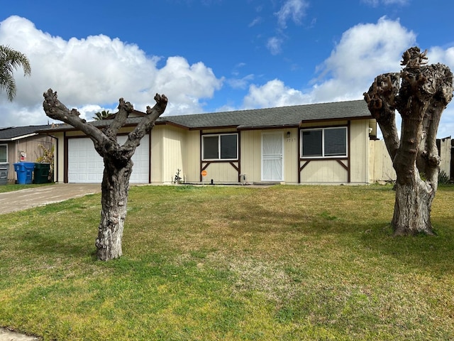 ranch-style house featuring a garage, driveway, and a front lawn