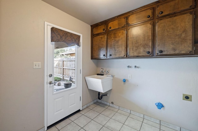 laundry room with washer hookup, cabinet space, electric dryer hookup, and light tile patterned floors