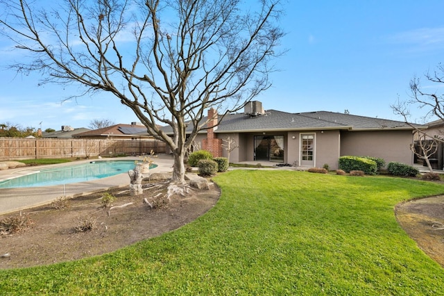 exterior space with a fenced backyard, central AC, and a fenced in pool