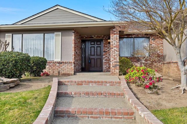 entrance to property with brick siding