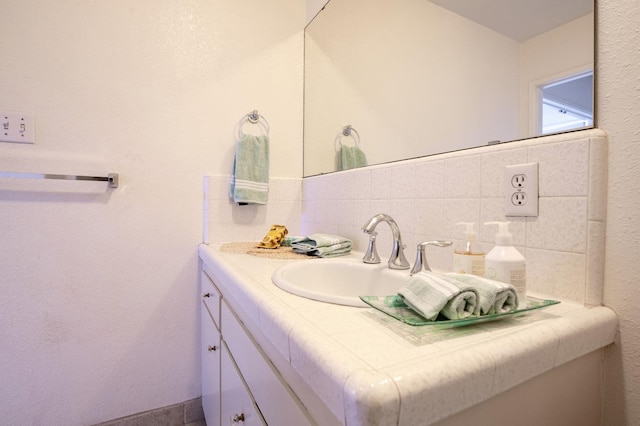 bathroom with backsplash and vanity