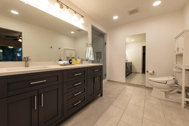 bathroom featuring double vanity, tile patterned flooring, visible vents, and a sink