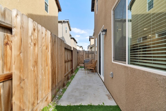 view of home's exterior featuring a patio, fence, and stucco siding