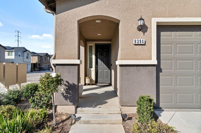 doorway to property featuring stucco siding