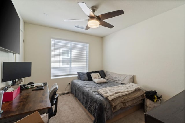 bedroom featuring ceiling fan, visible vents, and light colored carpet