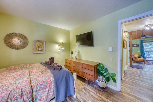 bedroom featuring baseboards and wood finished floors