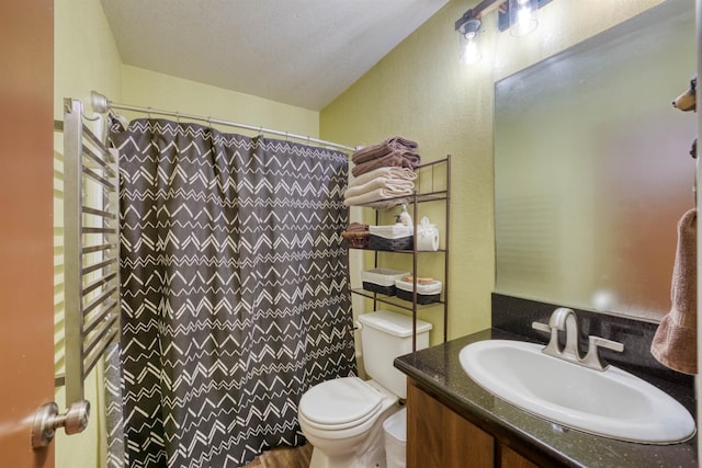 full bath with vanity, curtained shower, toilet, radiator heating unit, and a textured wall
