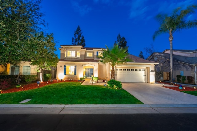 mediterranean / spanish home featuring concrete driveway, a lawn, an attached garage, and stucco siding