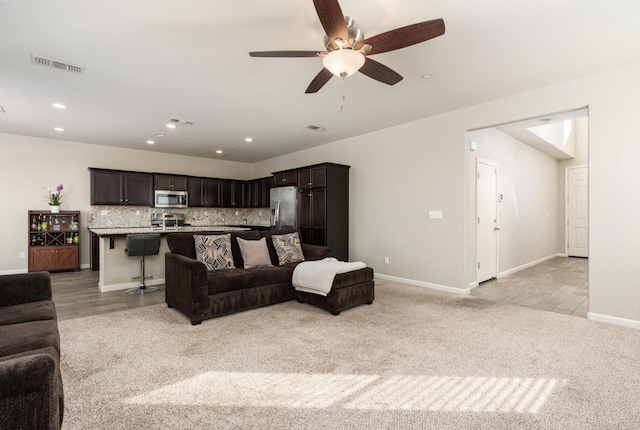 3384 Amanecer Ave, Clovis, CA 93619 - living area featuring light colored carpet, baseboards, ceiling fan, and recessed lighting