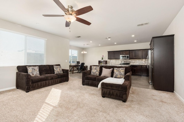 3384 Amanecer Ave, Clovis, CA 93619 - living room with light carpet, ceiling fan, and baseboards