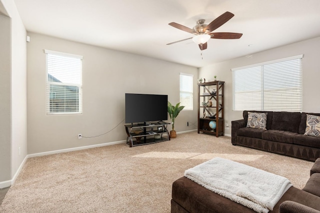 living room with light carpet, baseboards, and a healthy amount of sunlight