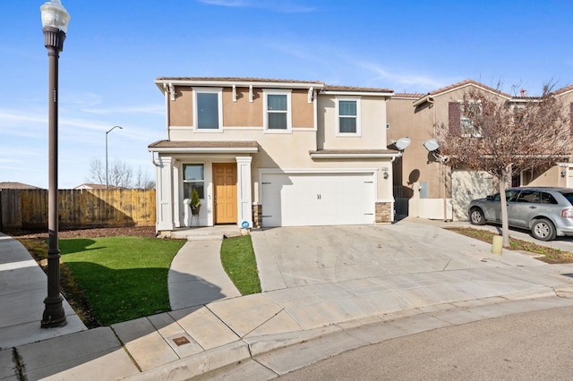 3384 Amanecer Ave, Clovis, CA 93619 - view of front facade featuring fence, a garage, stucco siding, driveway, and stone siding