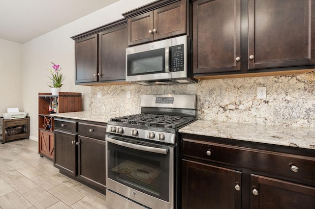 3384 Amanecer Ave, Clovis, CA 93619 - kitchen featuring stainless steel appliances, decorative backsplash, dark brown cabinets, and light stone countertops