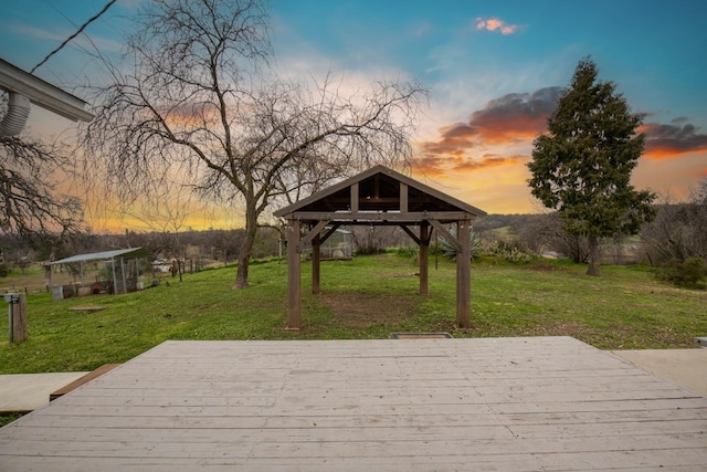 wooden deck featuring a lawn and a gazebo