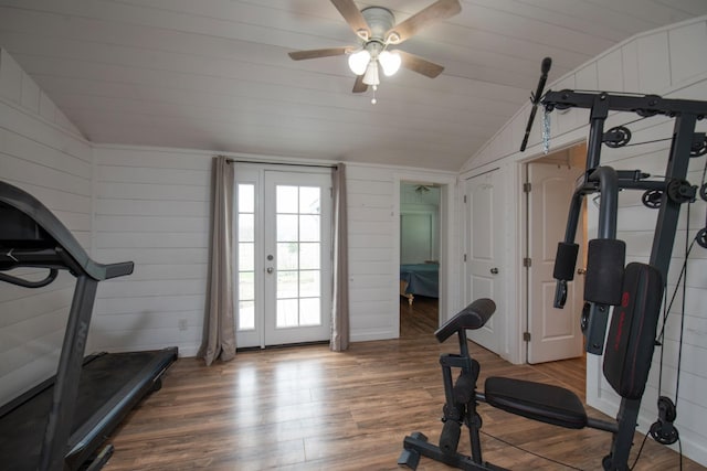 exercise room with lofted ceiling, french doors, and wood finished floors