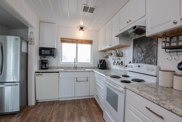 kitchen with white appliances, visible vents, under cabinet range hood, white cabinetry, and a sink