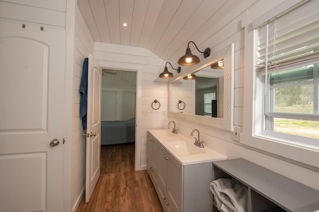 bathroom with connected bathroom, wood finished floors, wood ceiling, vanity, and vaulted ceiling