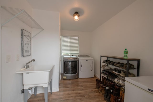 washroom with laundry area, washing machine and dryer, baseboards, and dark wood-style flooring