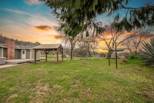 yard at dusk with a gazebo