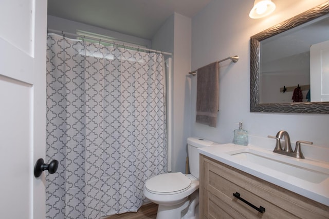 bathroom with toilet, curtained shower, and vanity