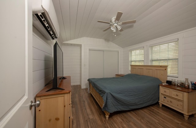 bedroom with dark wood finished floors, lofted ceiling, wood ceiling, a closet, and a wall mounted AC