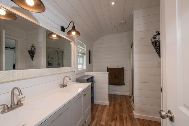 full bath featuring a stall shower, wood ceiling, a sink, and wood finished floors