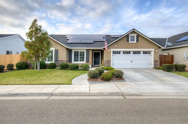 view of front facade featuring stone siding, fence, roof mounted solar panels, and stucco siding