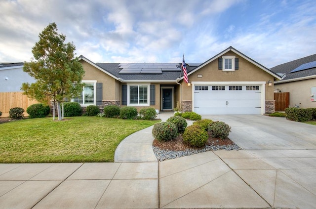 view of front of house with stone siding, driveway, roof mounted solar panels, stucco siding, and a front lawn