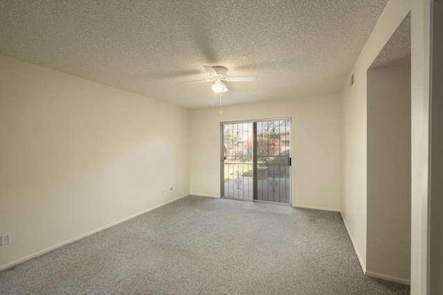 unfurnished room featuring a textured ceiling, carpet, a ceiling fan, and baseboards