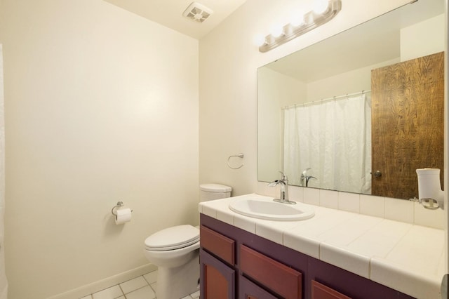 bathroom featuring baseboards, visible vents, toilet, tile patterned floors, and vanity