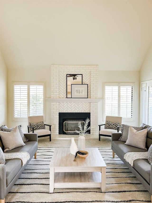 living room featuring vaulted ceiling and a fireplace