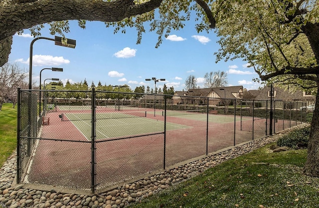 view of tennis court with fence