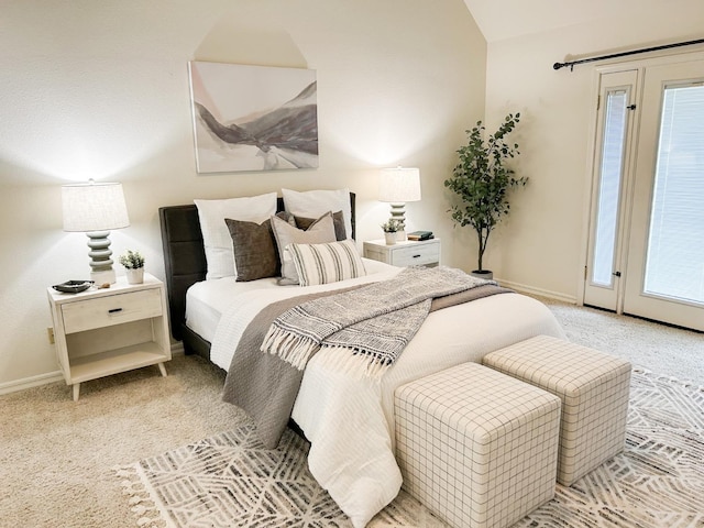 bedroom featuring light carpet, baseboards, access to exterior, vaulted ceiling, and multiple windows